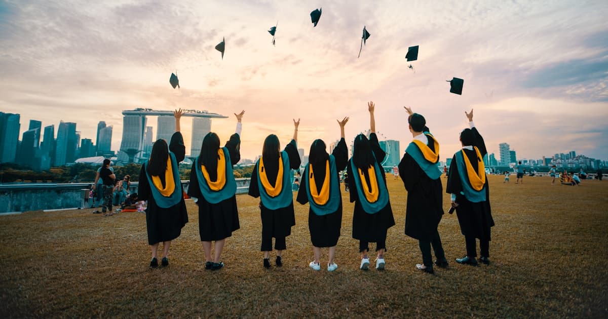 graduates throwing caps in the air at a commencement ceremony